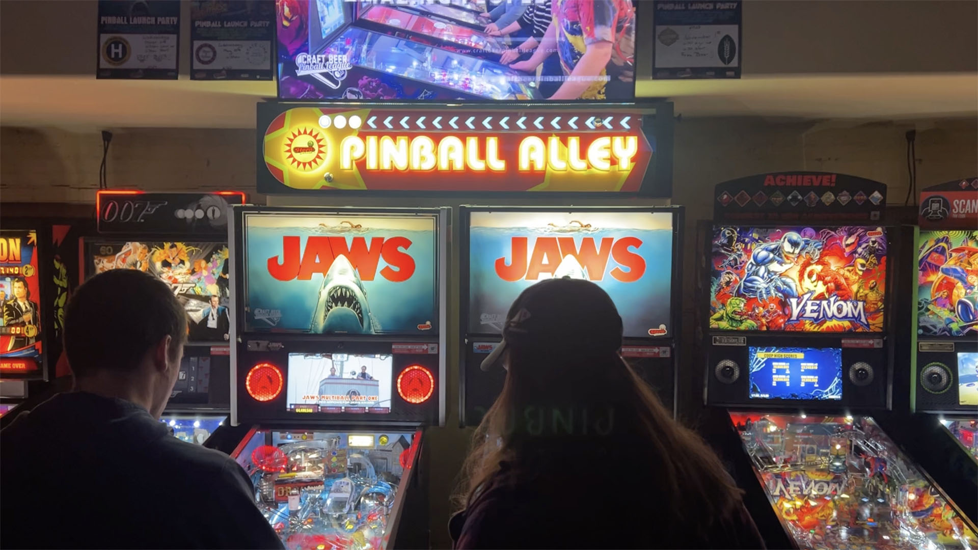 People playing Jaws Pinball