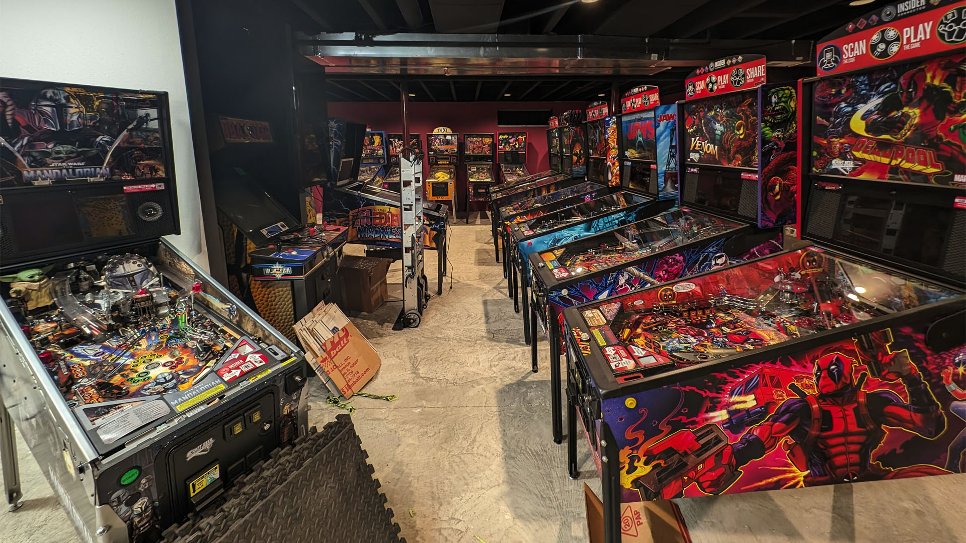 pinball tables in a basement